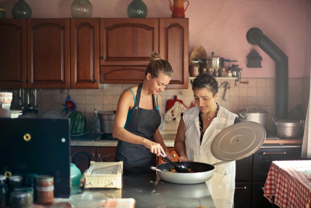 Woman and daughter cooking together