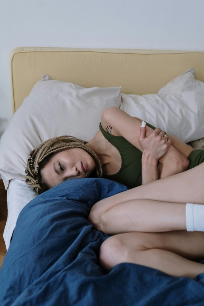 Woman on bed in pain